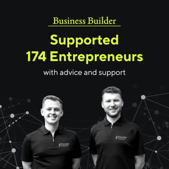 Two people in polo shirts smiling.