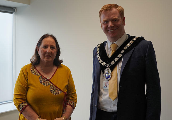 New Chair Councillor Adrian Tipple, standing wearing his chains, alongside outgoing Chair, Councillor Caroline Karimi-Ghovanlou