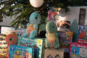 Photo of variety of toys sitting under a Christmas tree