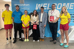 Group photo of leisure staff and Cllr Sharon Blundell, standing smiling at camera, holding the bleed kits.