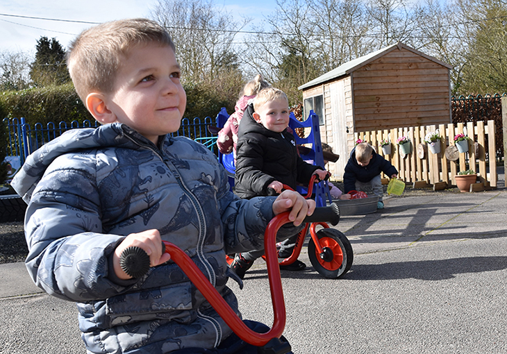 Two boys from Hemblington pre-school on trikes