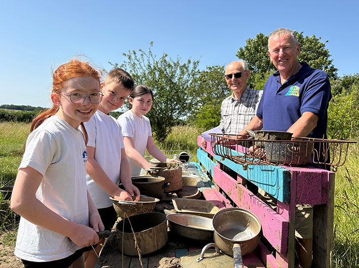 Brian Howes and Clive Leggett from Pulham Men’s Shed with children at Pulham CofE Primary Academy