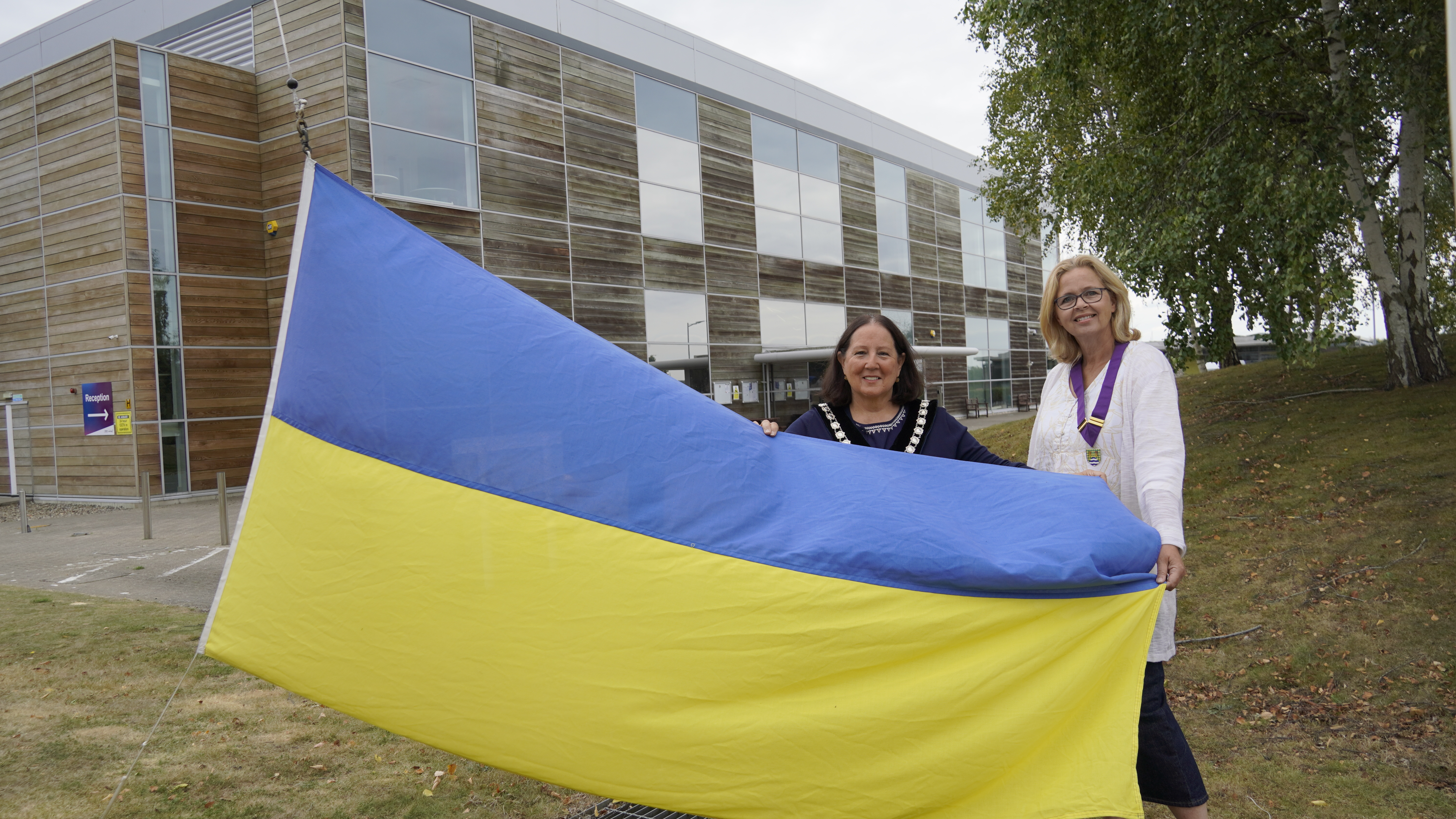 Ukrainian flag being held outside the Horizon Centre