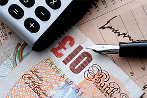 10 pound note with a pen and calculator
