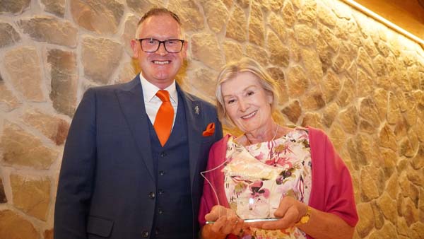 Lady receiving glass star trophy