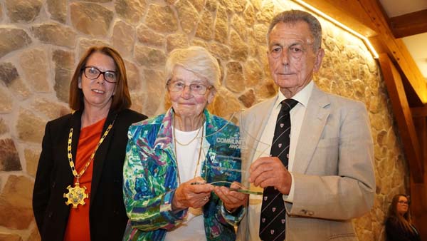 Chair of South Norfolk Council presenting an award to a man and woman