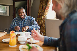 Two men eating breakfast in a bed and breakfast