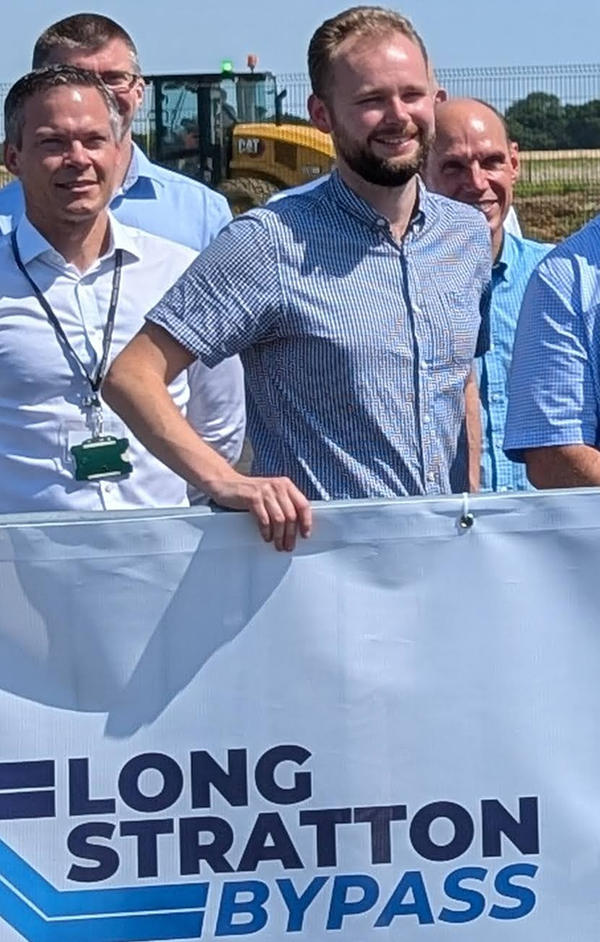 Cllr Daniel Elmer with a Long Stratton bypass sign