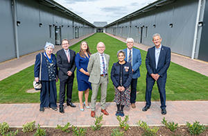 Representatives from respective partners standing outside the building