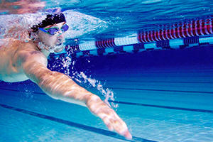 Man swimming under water in a pool