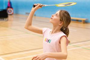 Young girl playing badminton