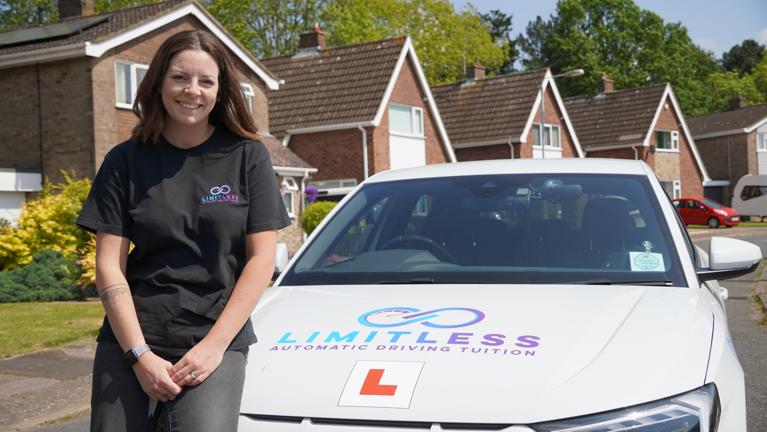 Instructor sitting on car bonnet