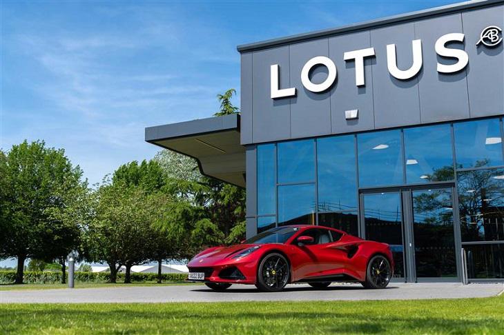 Red Lotus car sitting infront of glass fronted building