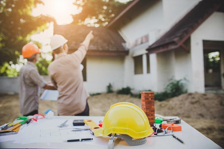 People wearing hard hats planning a building project