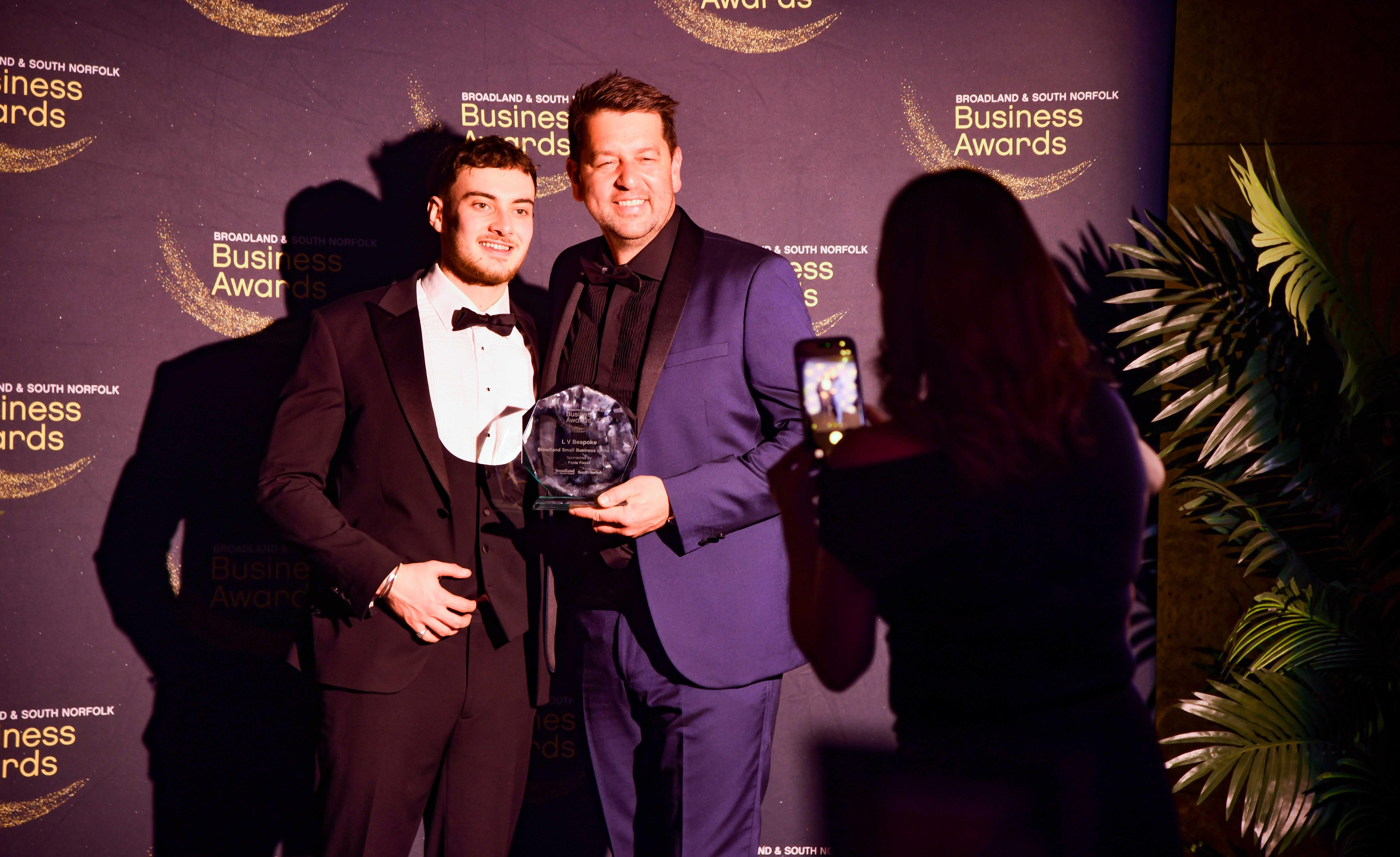 Guests posing infront of branded backdrop at the 2026 Business Awards