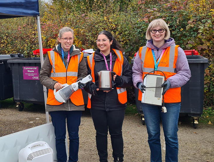 Recycling officers holding small electrical items