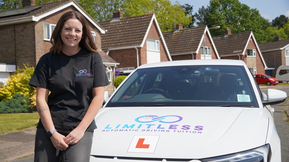 Tara Read from Limitless Driving School with a driving instructor car in the distance