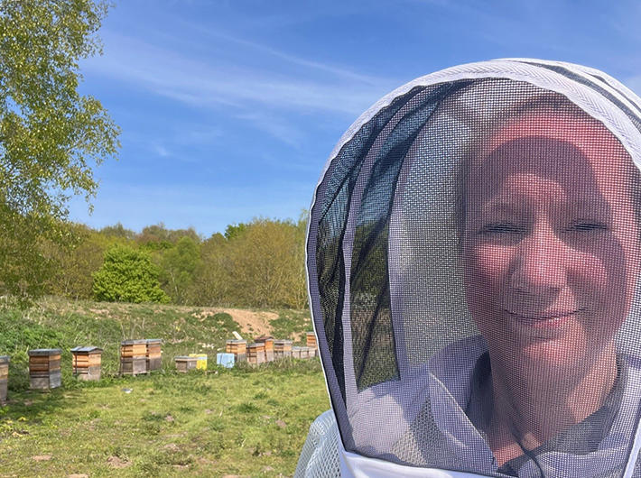 Tipsy Beekeeper outside with her hives