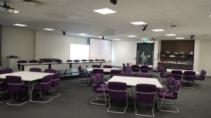 Tables and chairs arranged in groups of eight in the Yare Upper meeting room.