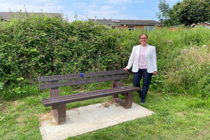Cllr Justine Thomas with the bench she helped fund