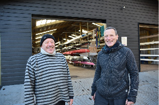 two members of Yare Boat Club  outside their boathouse