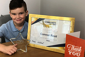 Connor Root with his trophy certificate and a thank you card