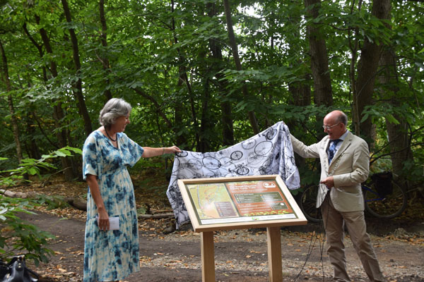 Cllr Jo Copplestone and Chairman Cllr John Fisher reveal the Sweet Chestnut Family Cycle Trail map at Broadland Country Park