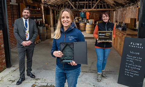 Flint vineyard accepting their trophy and certificate for the innovation in agriculture food and drink award