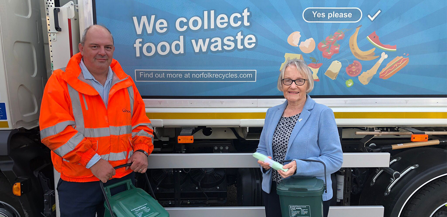Duncan McBurney from Veolia with Cllr Judy Leggett in front of a food waste truck holding food caddies