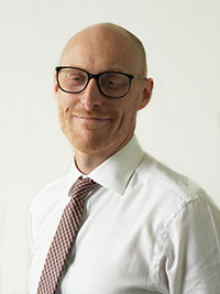 Man in white shirt, tie and glasses