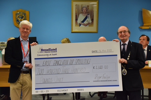 Matthew Jones receives a cheque from Roger Foulger.