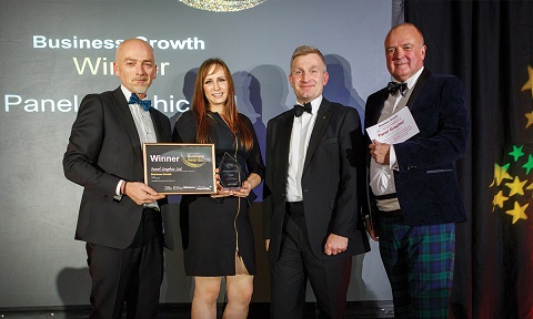 Panel graphic accepting their trophy and certificate for the business growth award