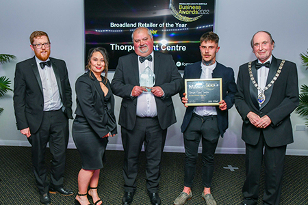 thorpe plant centre accepting their 2022 business award trophy and certificate from chairman of broadland council cllr roger foulger