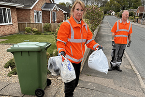 Bin crew collecting carrier bags containing electricals, textiles and batteries